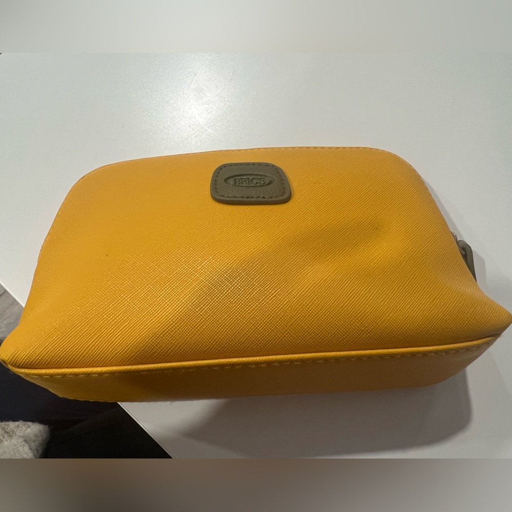 Bric's Mustard Yellow business class amenity kit for Qatar Airways (empty)
